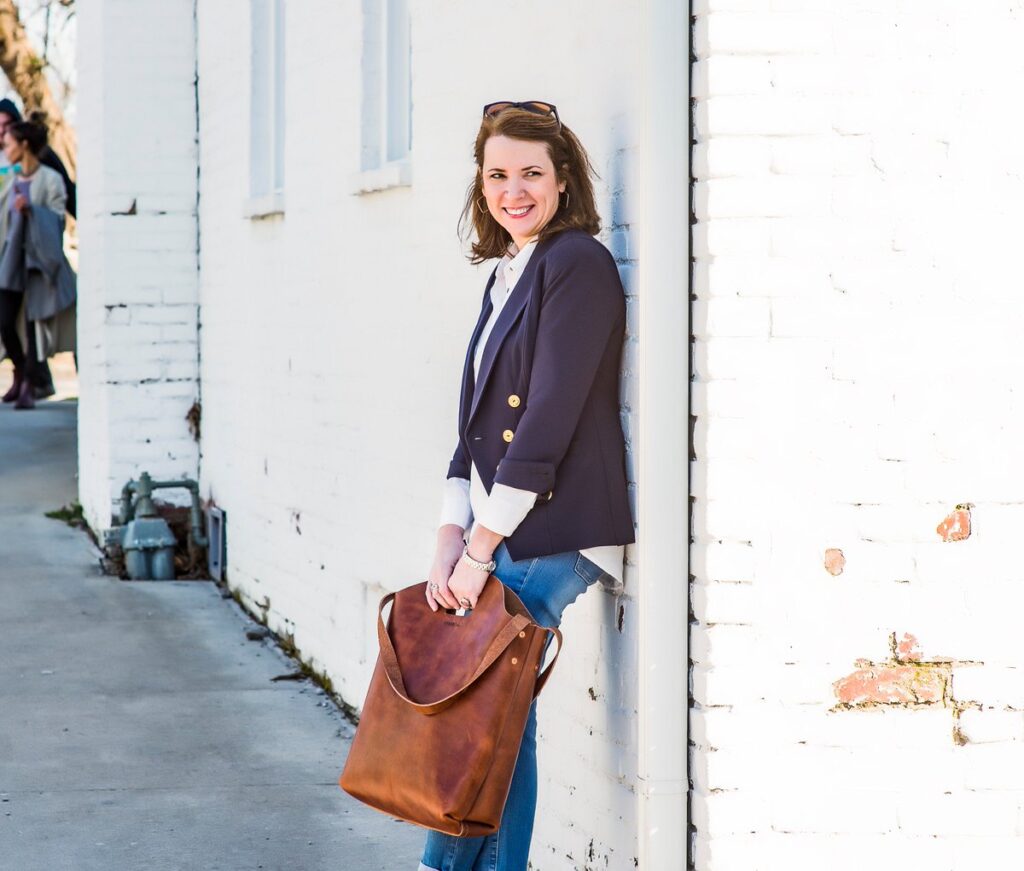 Business woman holding a giant bag of cash from her online store.