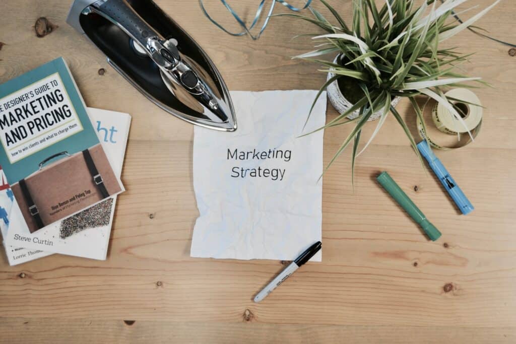 a messy desk with papers scattered with different marketing tactics on them