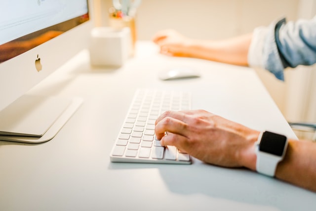 close up of man's hand on computer keyboard