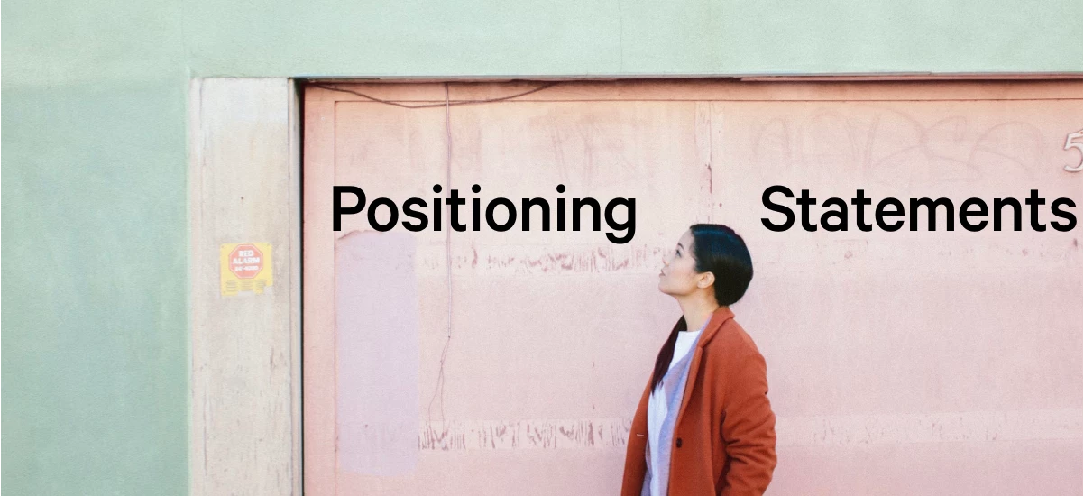 An image of a woman looking up at the words "Positioning Statements"